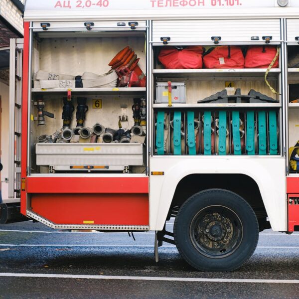 Close-up of a fire truck's open compartment showing firefighting tools.
